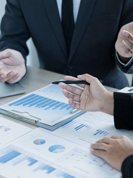 Two business leaders talk about charts, financial graphs showing results are analyzing and calculating planning strategies, business success building processes.